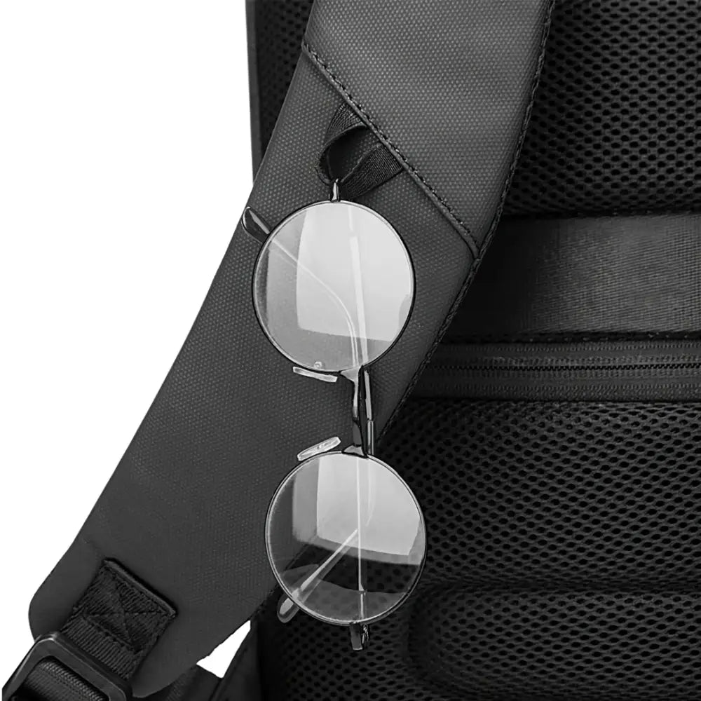 Sac à dos antivol ordinateur noir avec lunettes pour une sécurité optimale