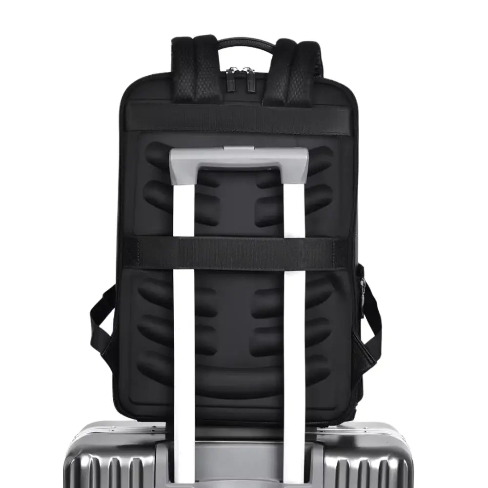 Sac à dos cuir de travail Ambition noir posé sur une valise