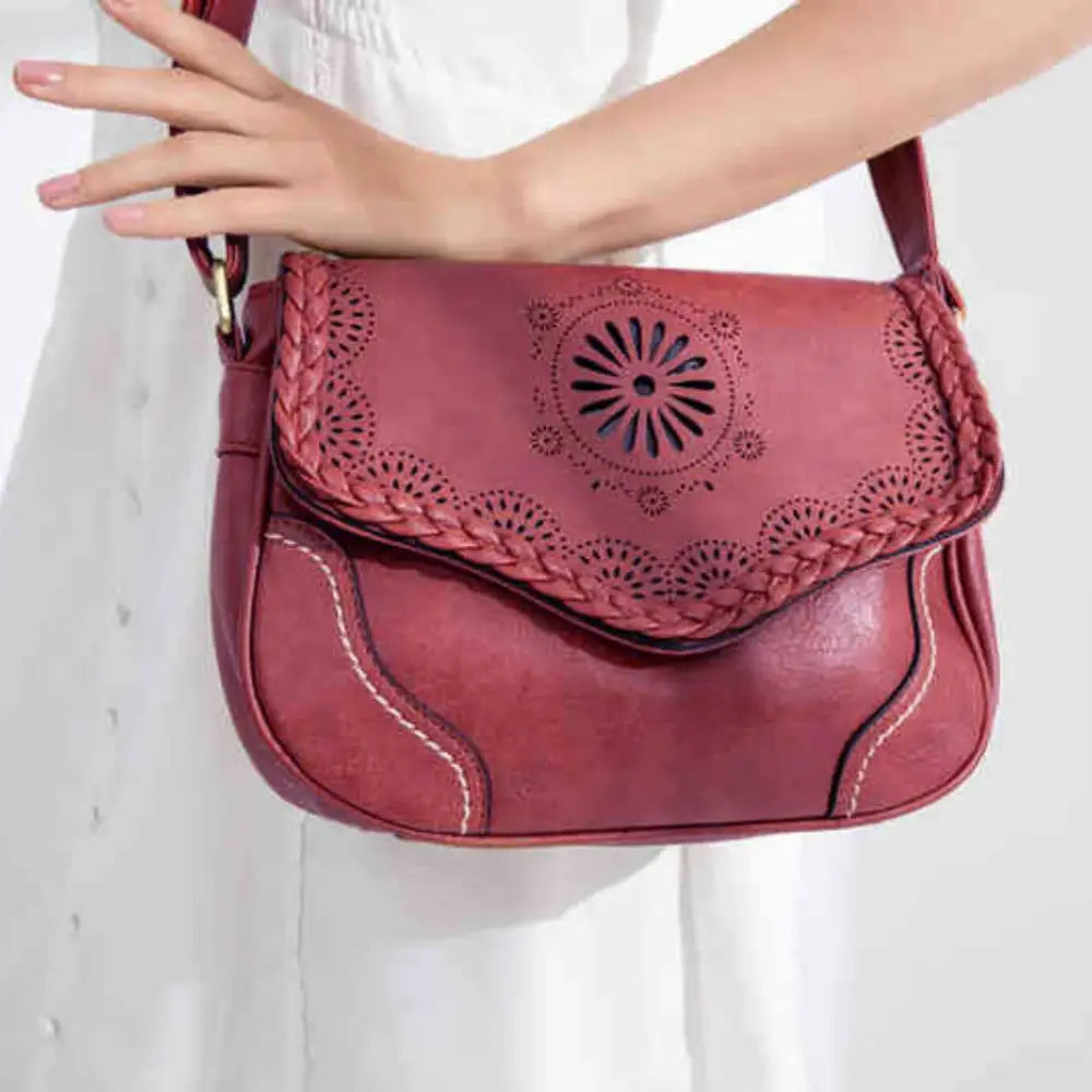 Sac à main cuir vintage rouge avec découperies décoratives, parfait pour un style main cuir vintage