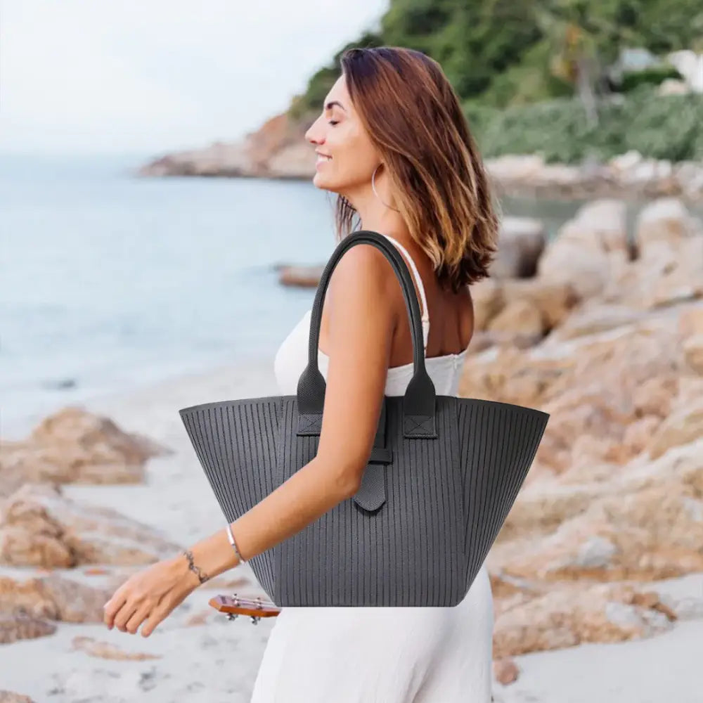 Sac de plage en tissu Brisa avec tote gris à rayures verticales et poignées noires, parfait pour crème solaire