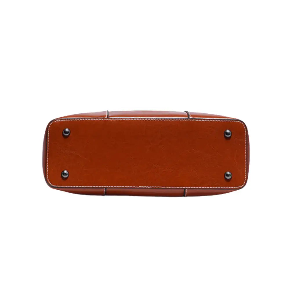 Base en cuir marron du sac à main porté épaule Eternal, idéal pour bureau aux sorties