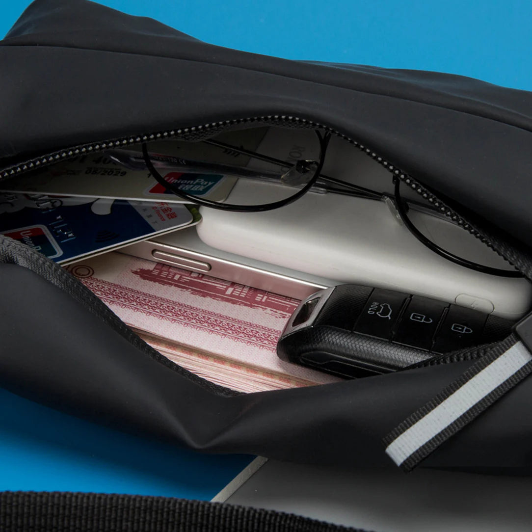 Sac bandoulière banane Swift ouverte montrant son contenu noir